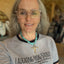 Woman wearing an Evening Star cross pendant on a chunky turquoise howlite beaded choker - Spoon cross choker necklace - handcrafted from upcycled vintage silverware - Laughing Frog Studio