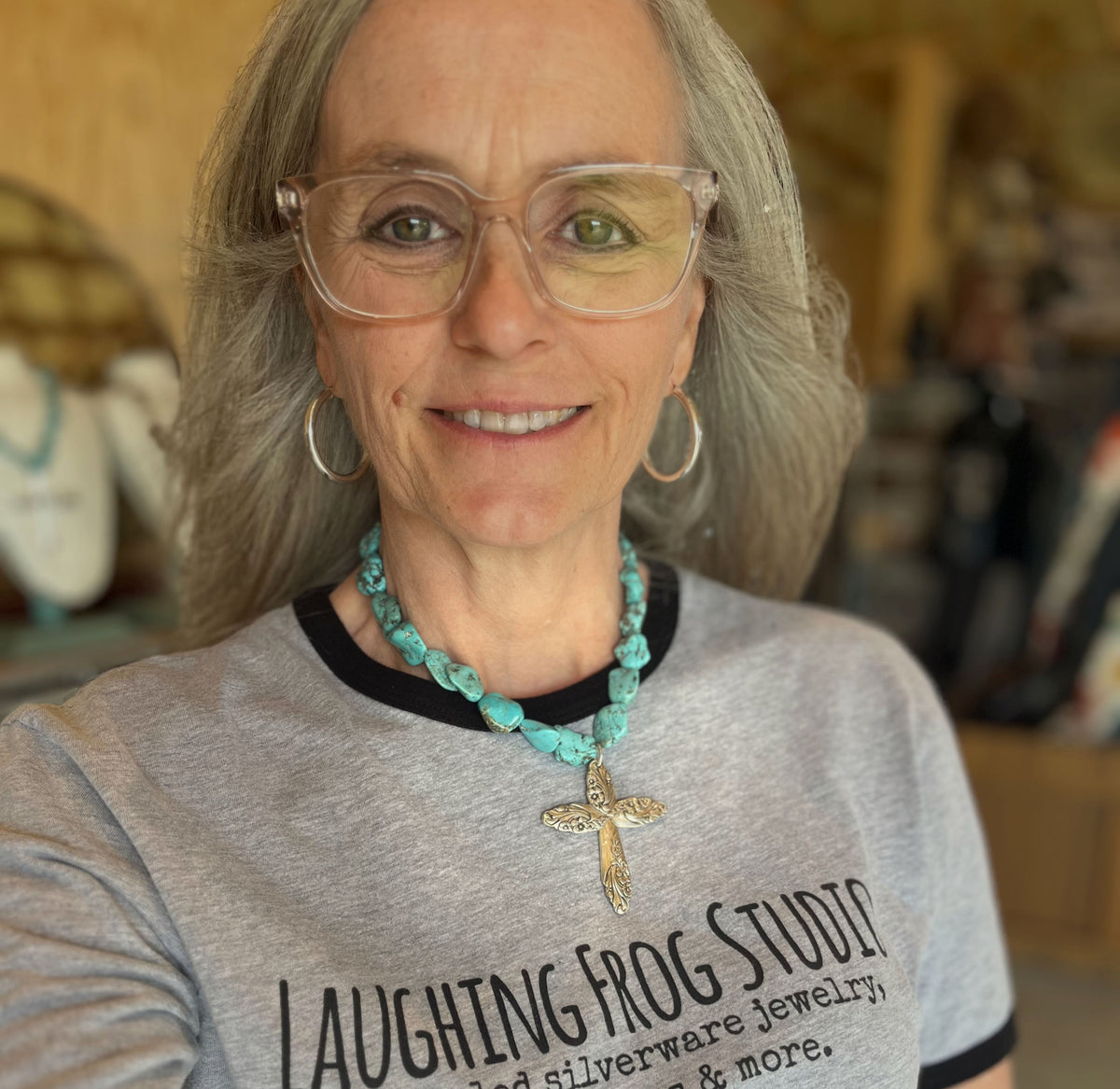 Woman wearing an Evening Star cross pendant on a chunky turquoise howlite beaded choker - Spoon cross choker necklace - handcrafted from upcycled vintage silverware - Laughing Frog Studio