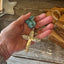 Evening Star floral cross pendant held in an open hand to show size, with turquoise howlite beads - Spoon cross choker necklace - handcrafted from upcycled vintage silverware - Laughing Frog Studio