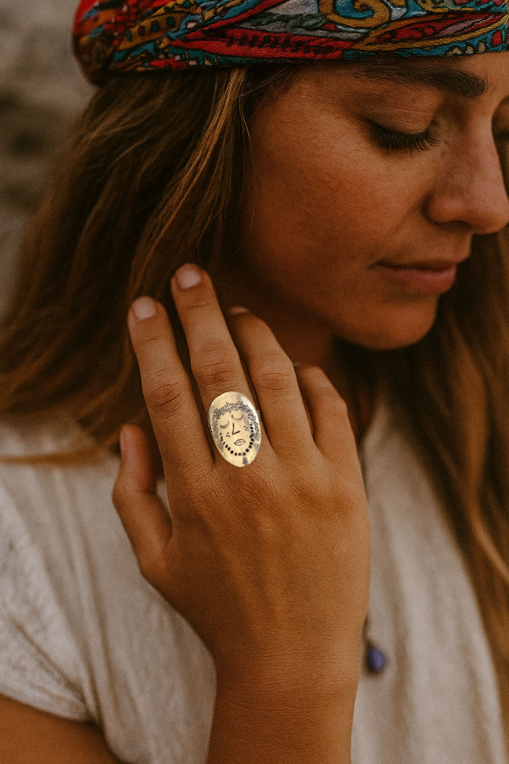 Woman in colorful head wrap wearing the Celeste Women of Nature hand-stamped spoon ring — upcycled vintage silverware ring