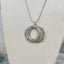 Close up of stamping detail on hand-stamped kinetic triple spoon necklace with movement rings - Spoon Necklace - handcrafted from upcycled vintage silverware - Laughing Frog Studio