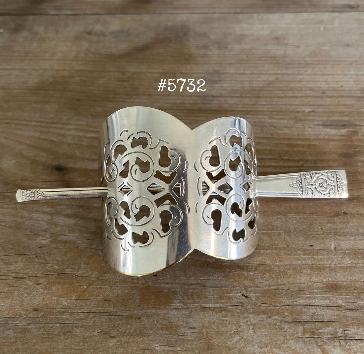 Cake server hair barrette detail view showing punched filigree pattern and craftsmanship