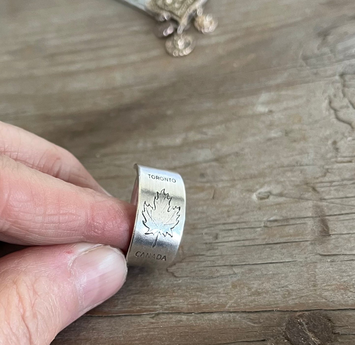Close-up of TORONTO CANADA pattern spoon ring showing iconic Canadian maple leaf design detail