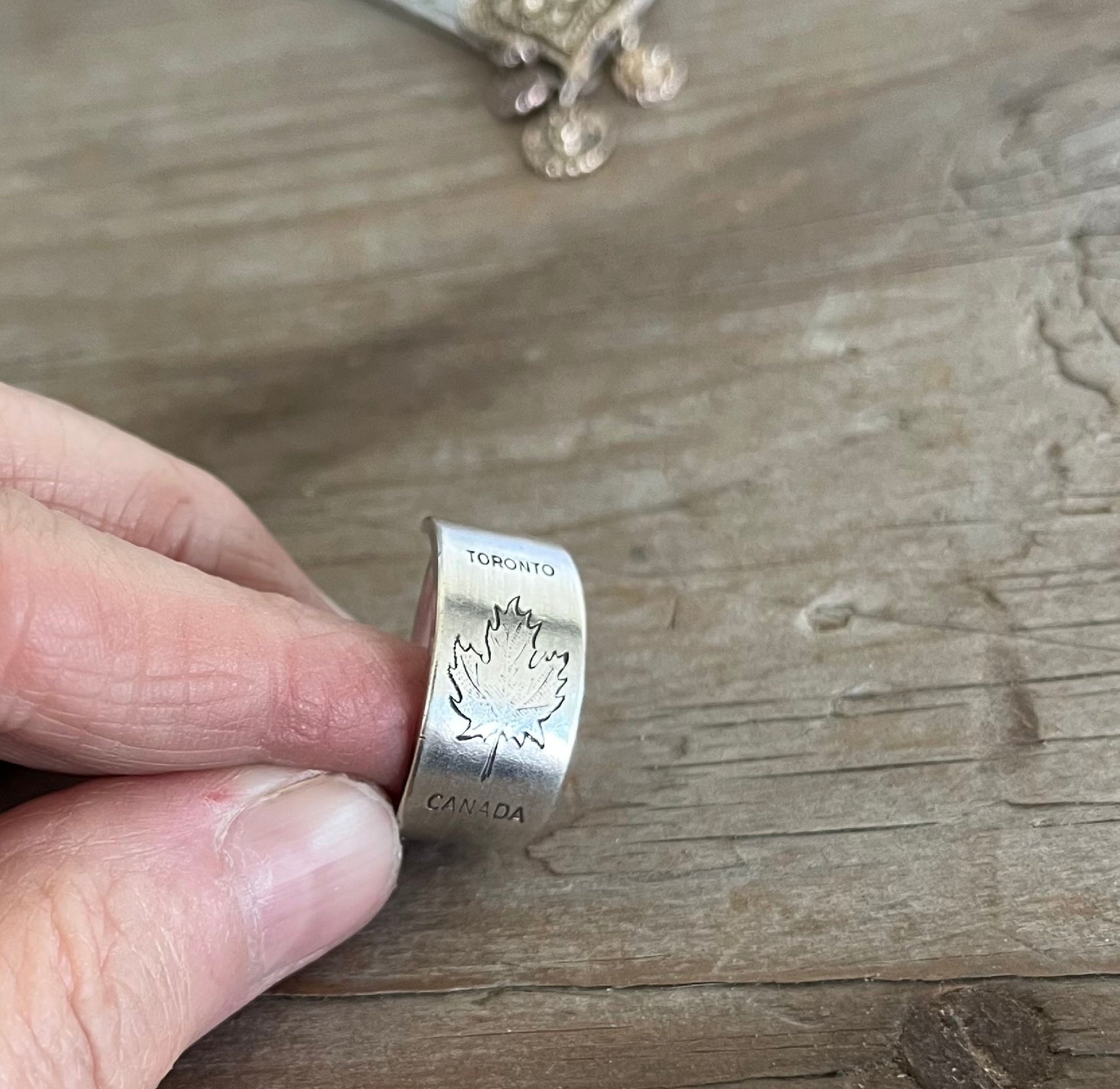 Close-up of TORONTO CANADA pattern spoon ring showing iconic Canadian maple leaf design detail