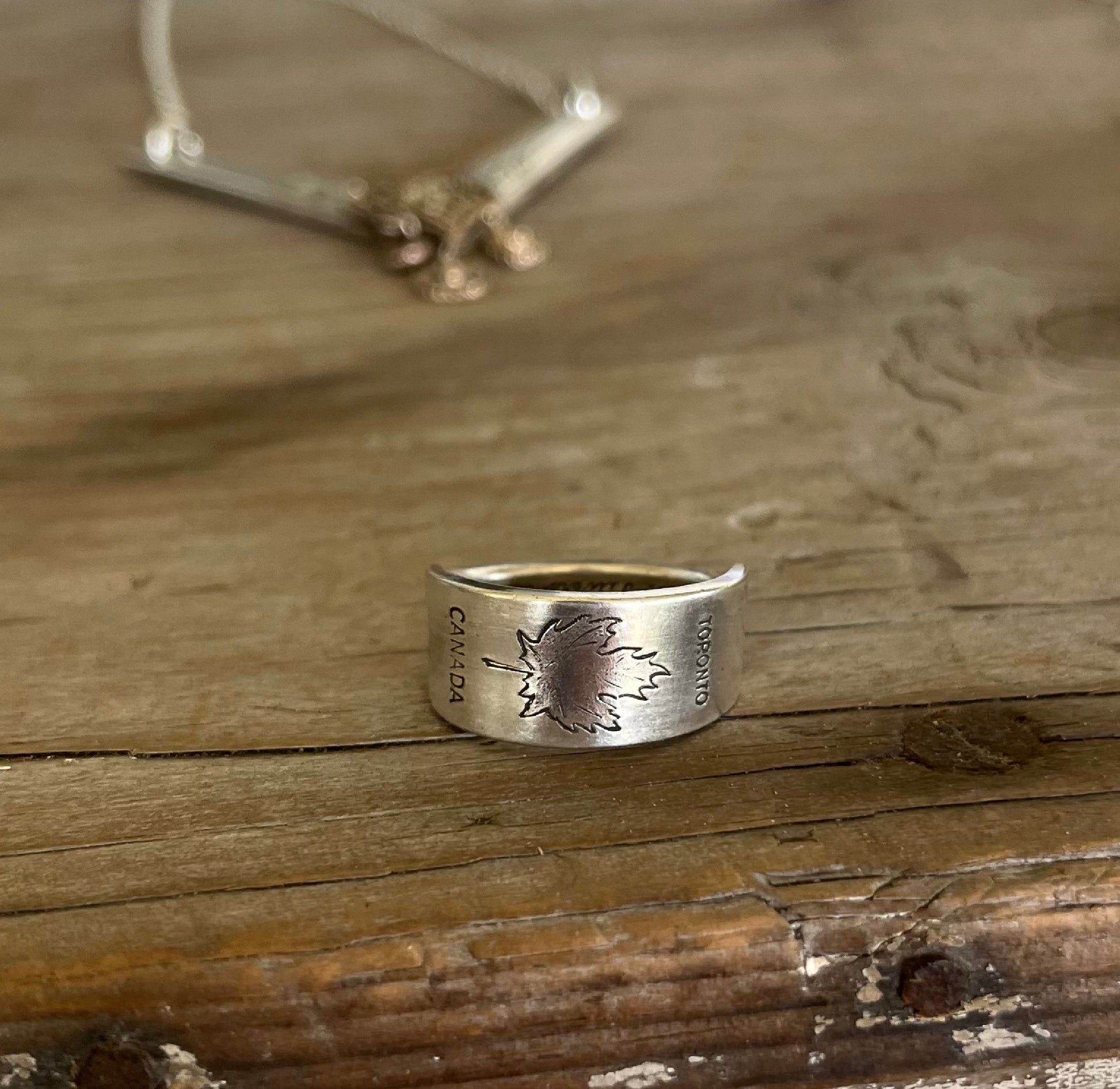 Close-up of TORONTO CANADA pattern silverware ring showing iconic Canadian design detail