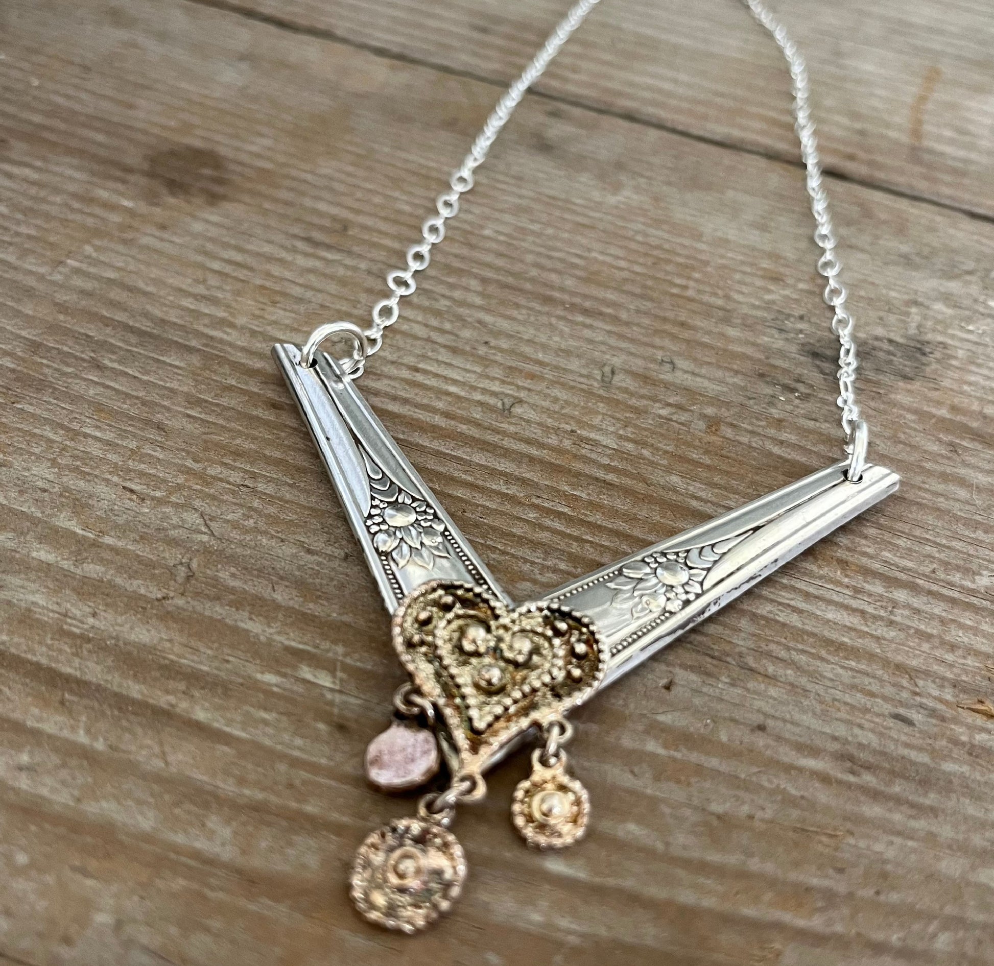 Side view of upcycled silverplate chevron choker on model showing 7-inch drop and 3-inch wide pendant, bold vintage silverware jewelry