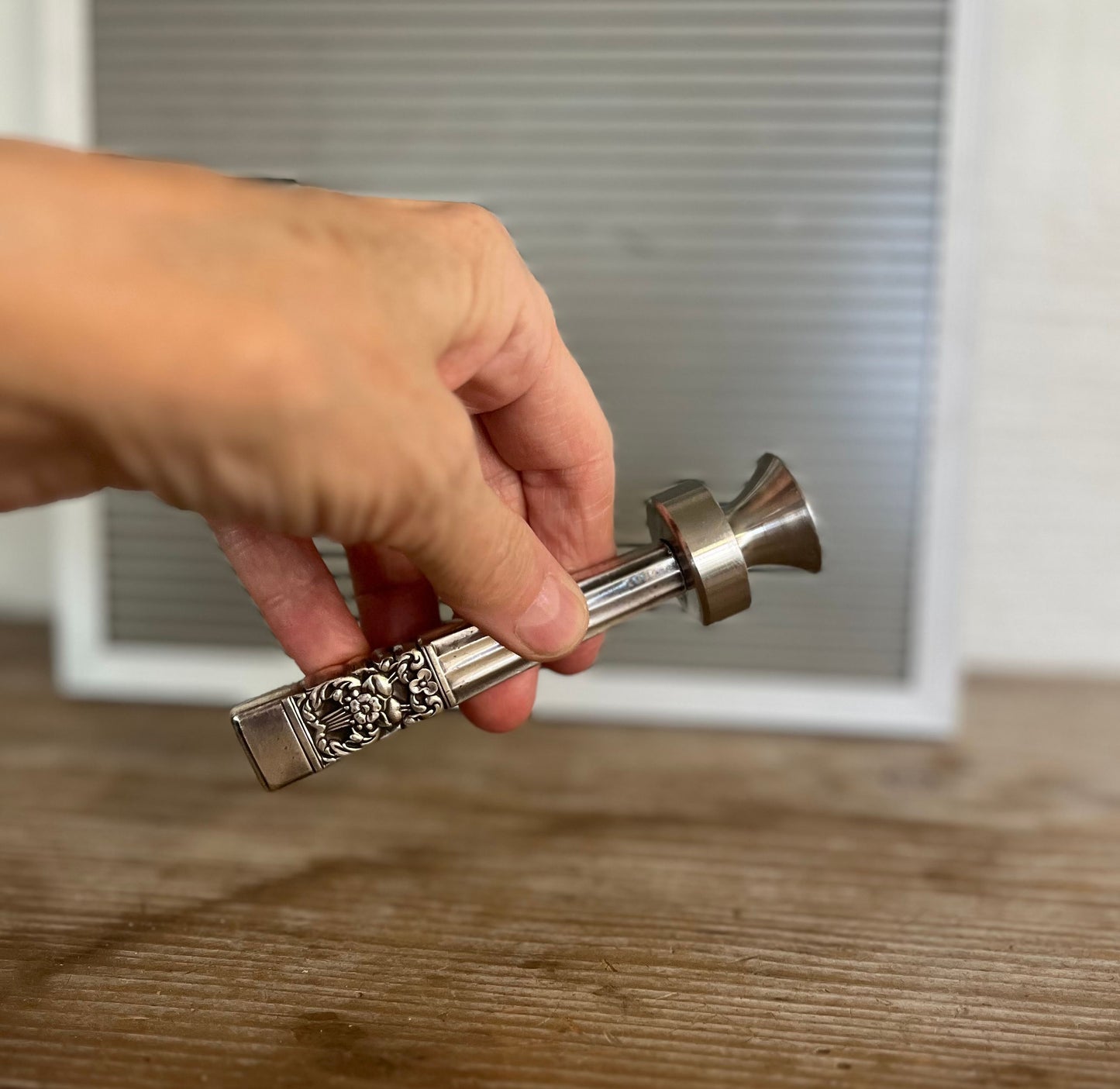 Coronation knife handle bottle opener with art deco design - handcrafted upcycled vintage silverware bar tool - shown in hand for size and scale