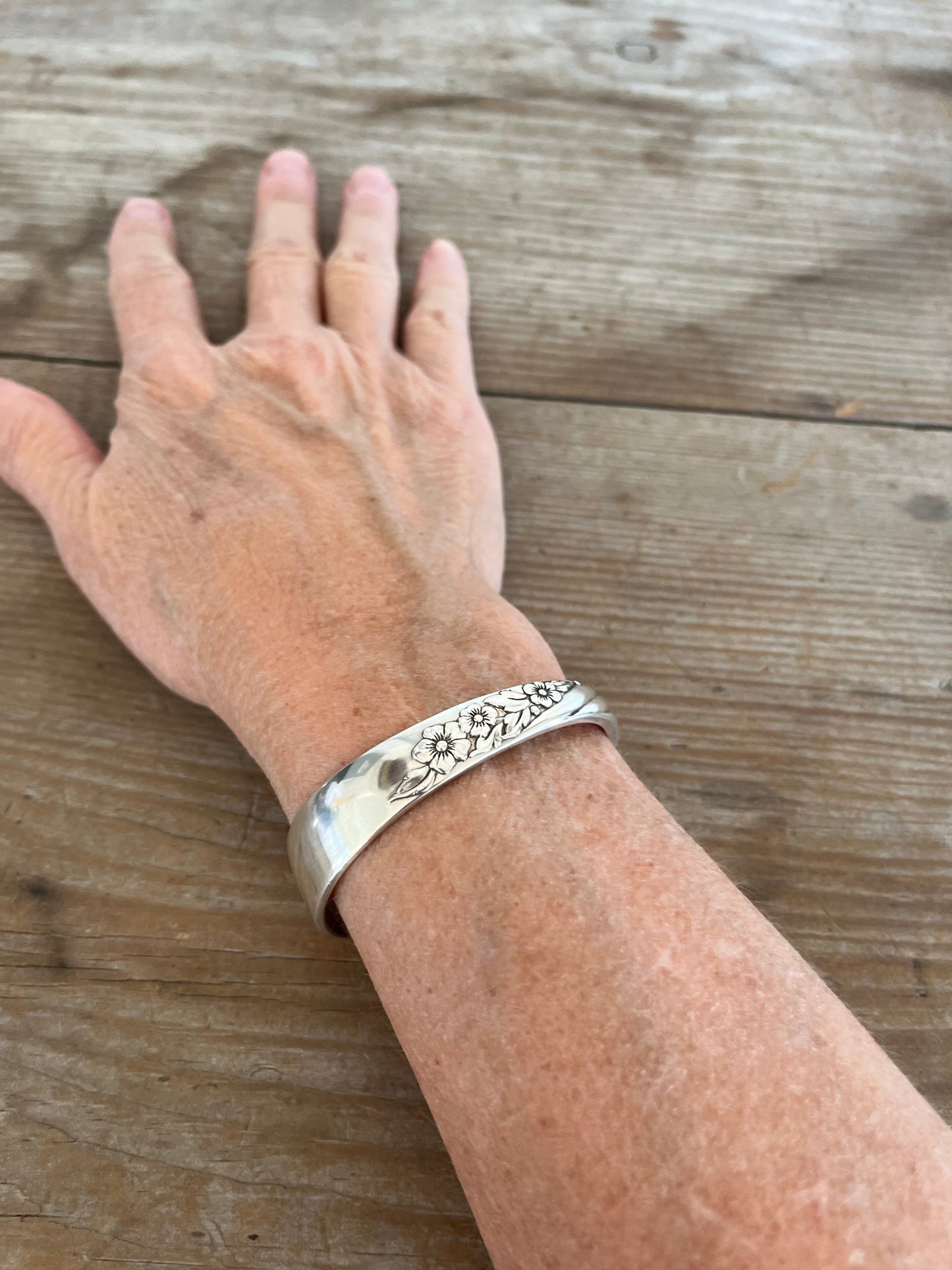 Vanessa spoon cuff bracelet shown on model wrist - vintage Oneida silverplate with sculptural Art Nouveau design