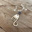 Close-up detail of handcrafted fork elephant pendant with smoky blue bead, 1.75 inches tall