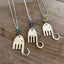 Trio of handcrafted fork elephant pendants showing variety of bead colors and body shapes