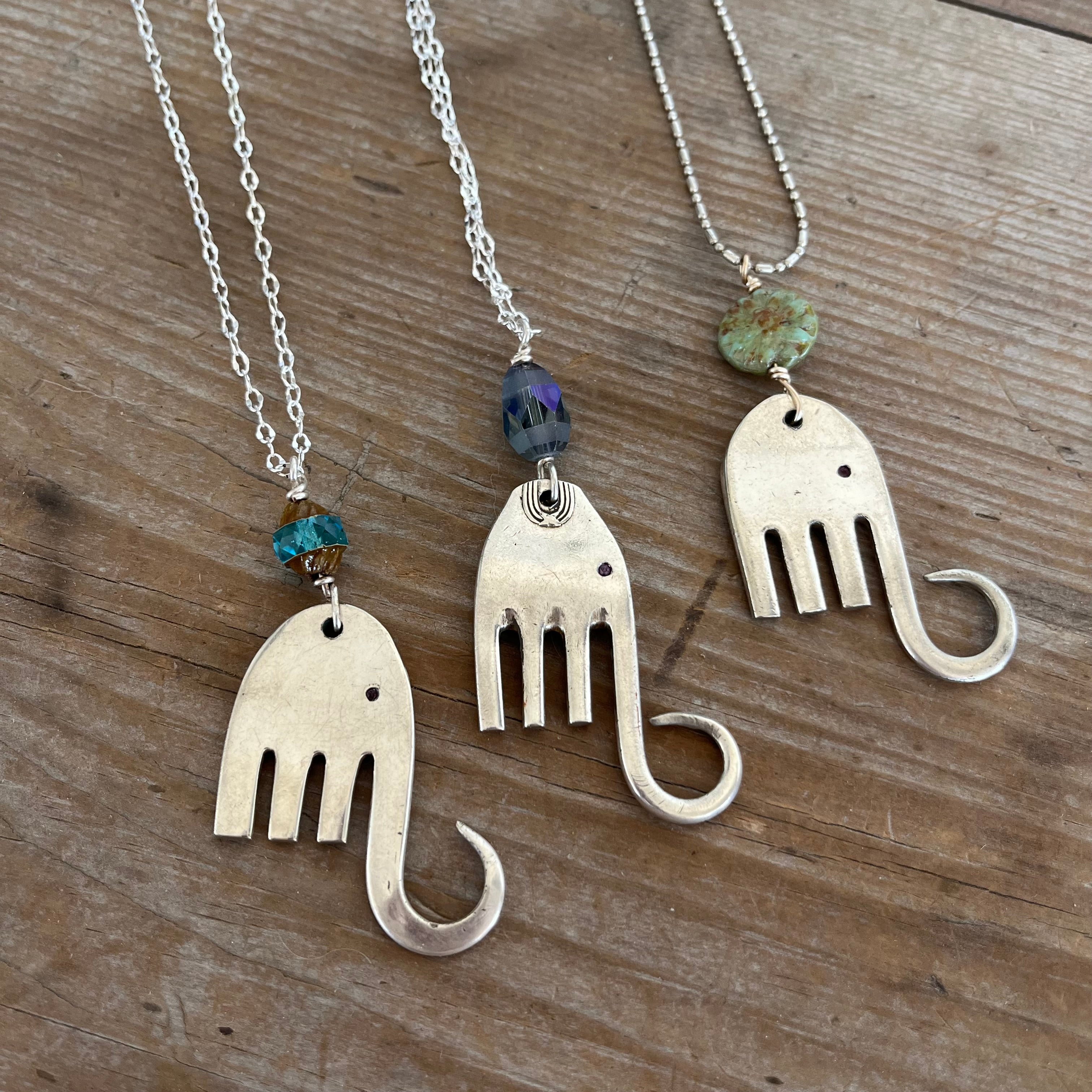 Trio of handcrafted fork elephant pendants showing variety of bead colors and body shapes
