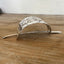 Side view of Art Deco cake server hair barrette showing curved vintage silverplate half-moon shape