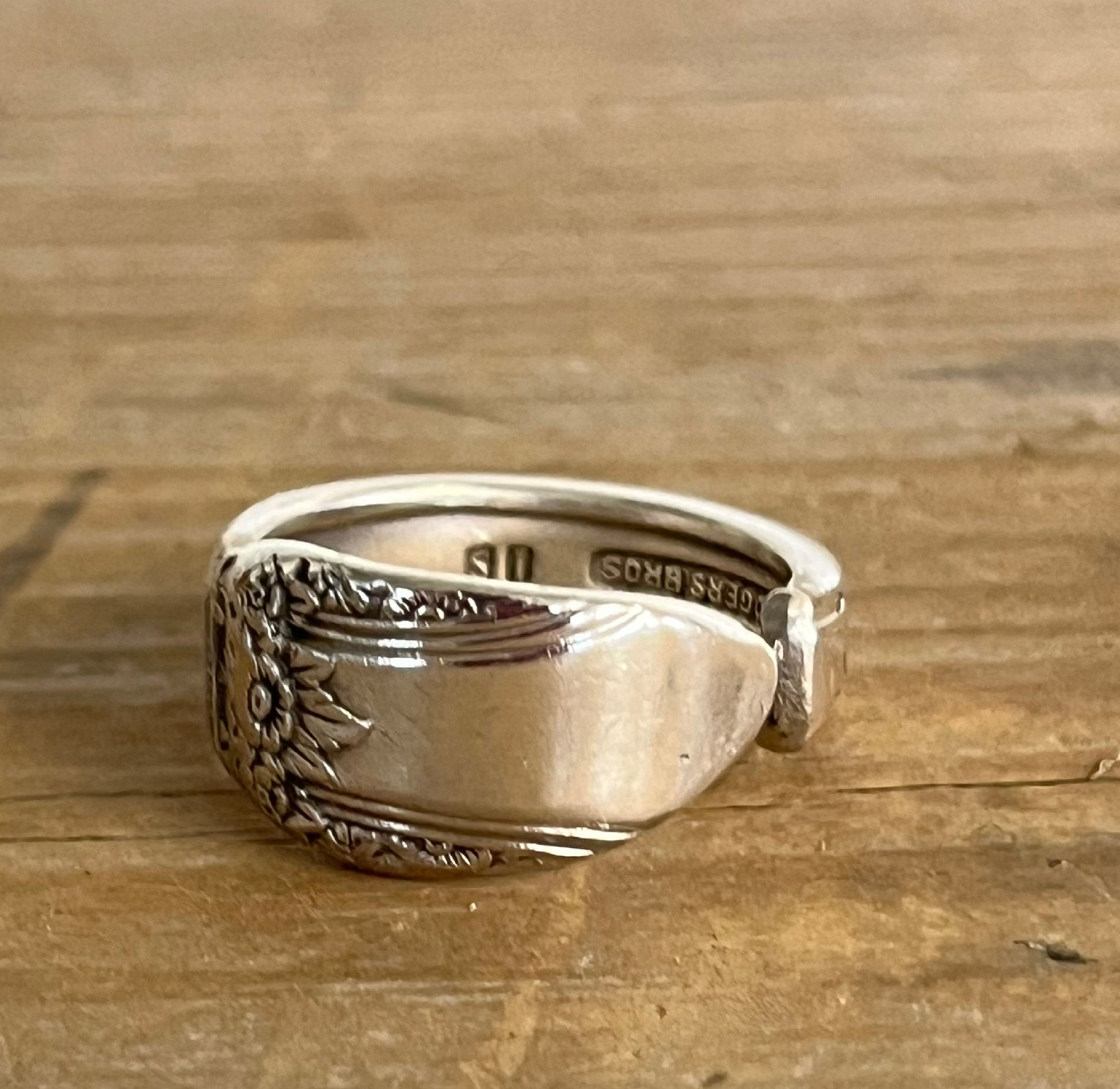 Close-up of FIRST LOVE pattern spoon ring showing vintage silverware detail 