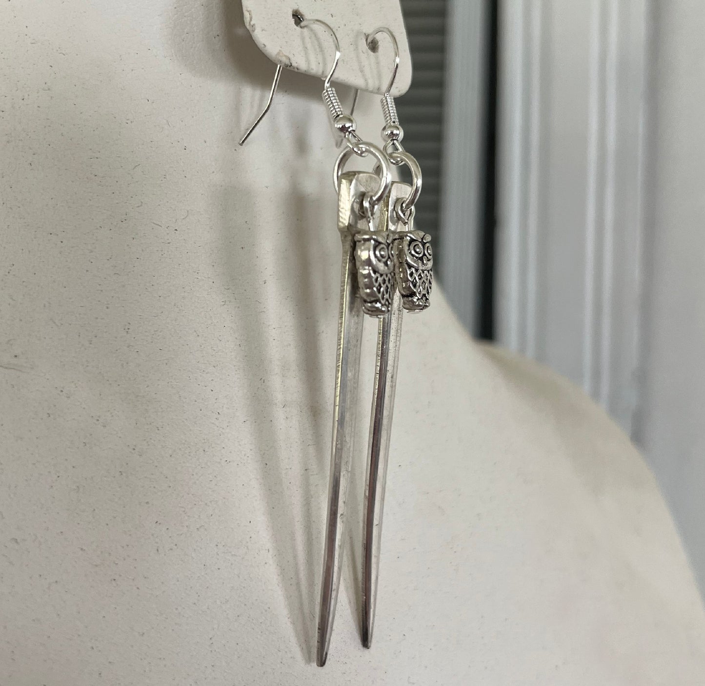 Fork tine earrings with playful owl charm beads showing one-of-a-kind upcycled silverware design
