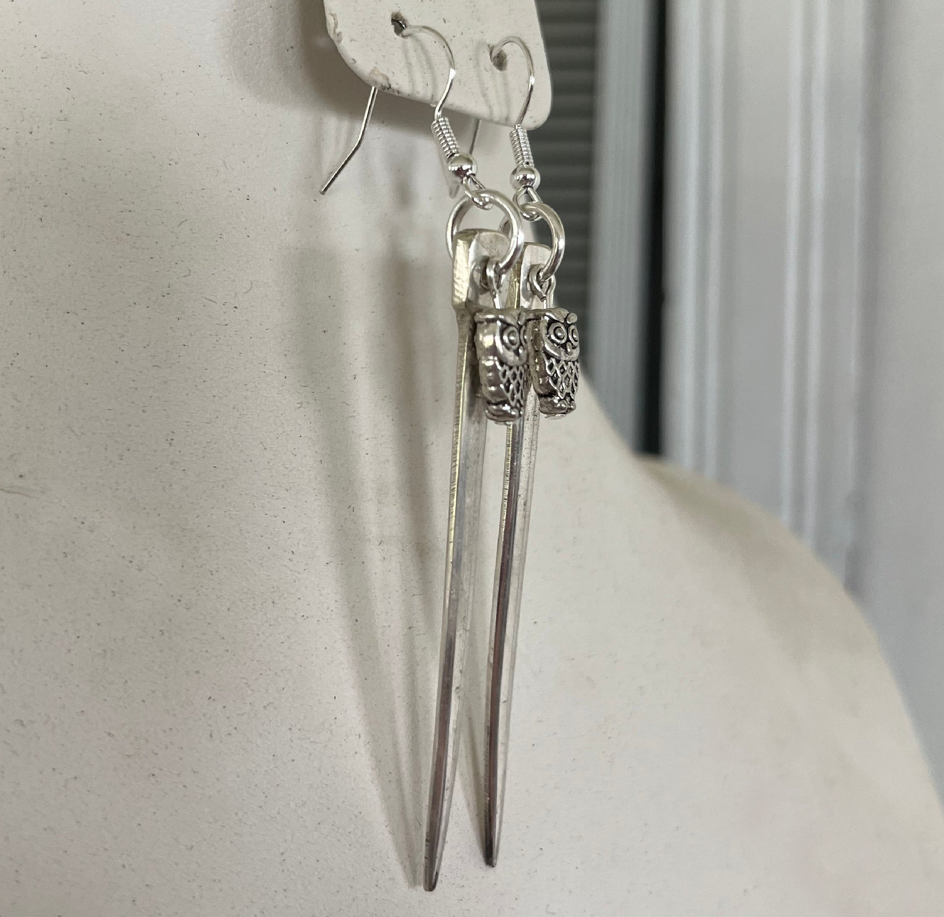 Fork tine earrings with playful owl charm beads showing one-of-a-kind upcycled silverware design