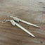 Close-up detail of edgy fork tine earrings with owl charms showing sharp clean lines, 3.25 inches long