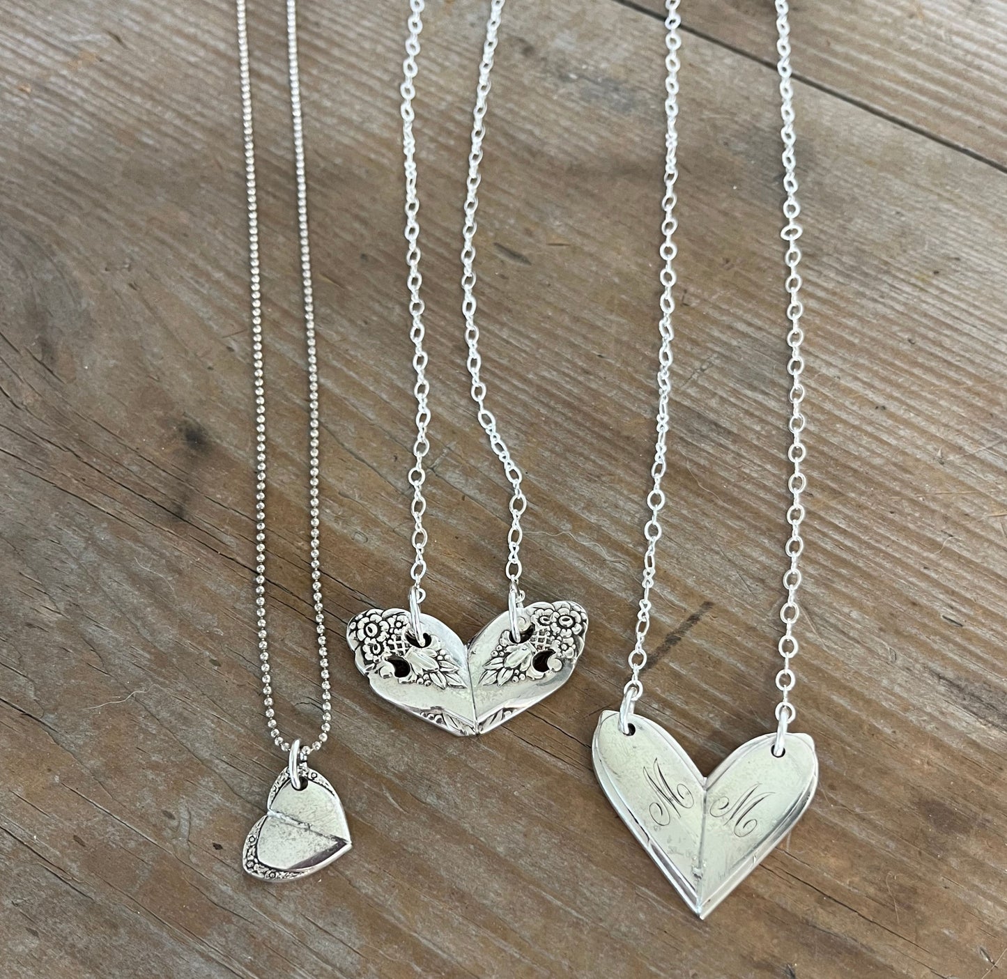 Collection of three fork heart necklaces displaying variety of vintage silverware patterns