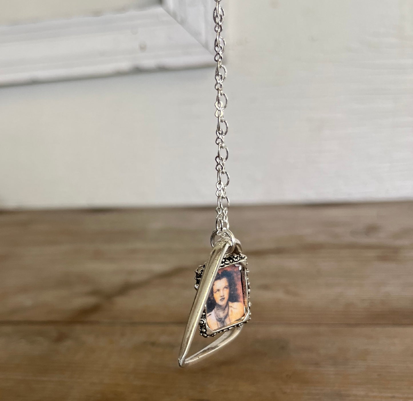 Side angle of fork tine heart necklace with customizable photo frame, romantic upcycled silverplate keepsake pendant