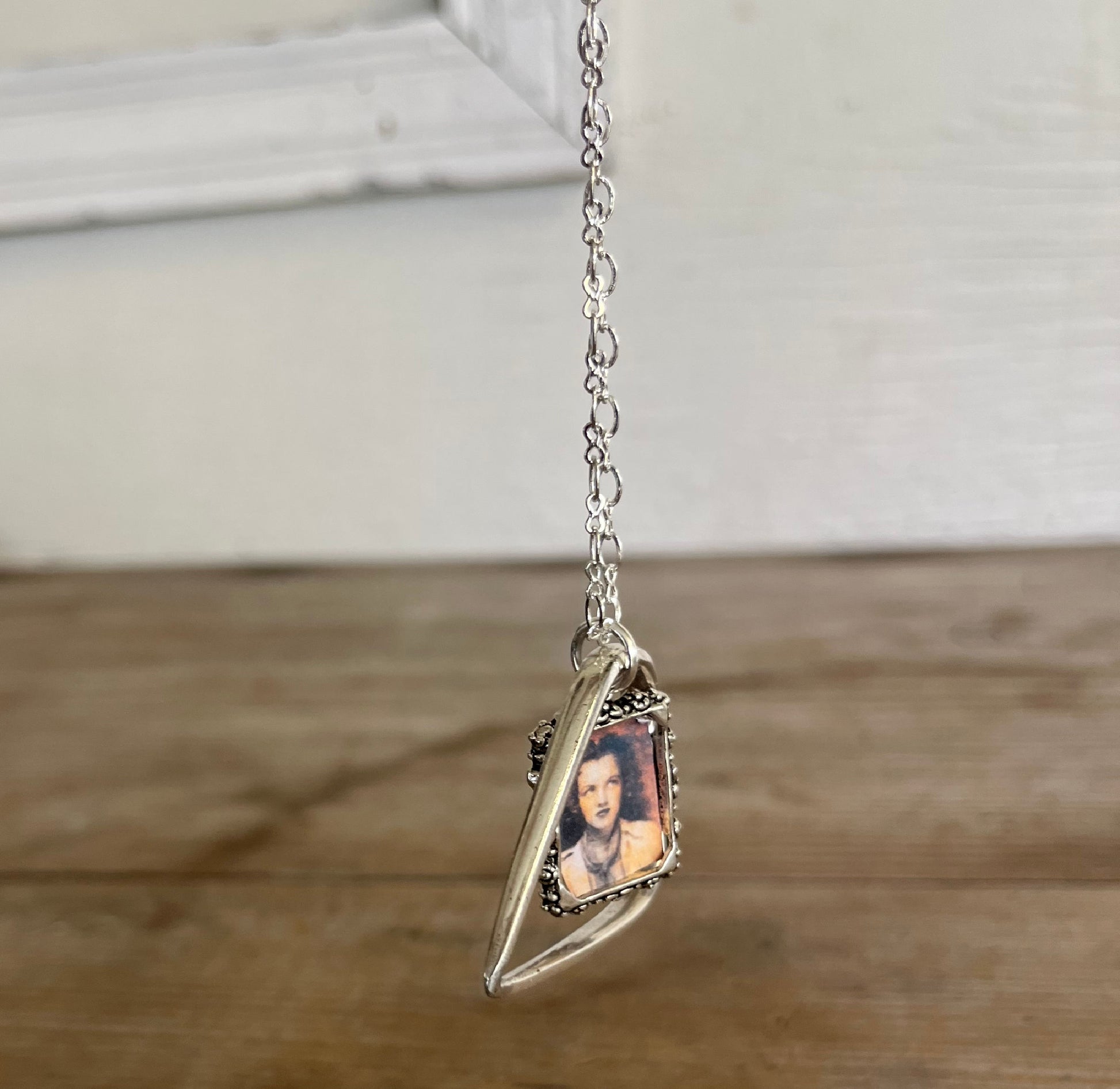 Side angle of fork tine heart necklace with customizable photo frame, romantic upcycled silverplate keepsake pendant