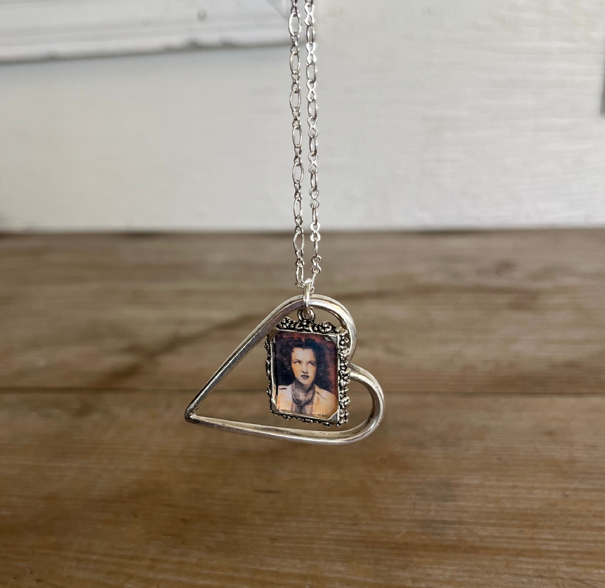 Detail view of handmade floating heart necklace showing moveable ring attachment, one-of-a-kind vintage silverware jewelry