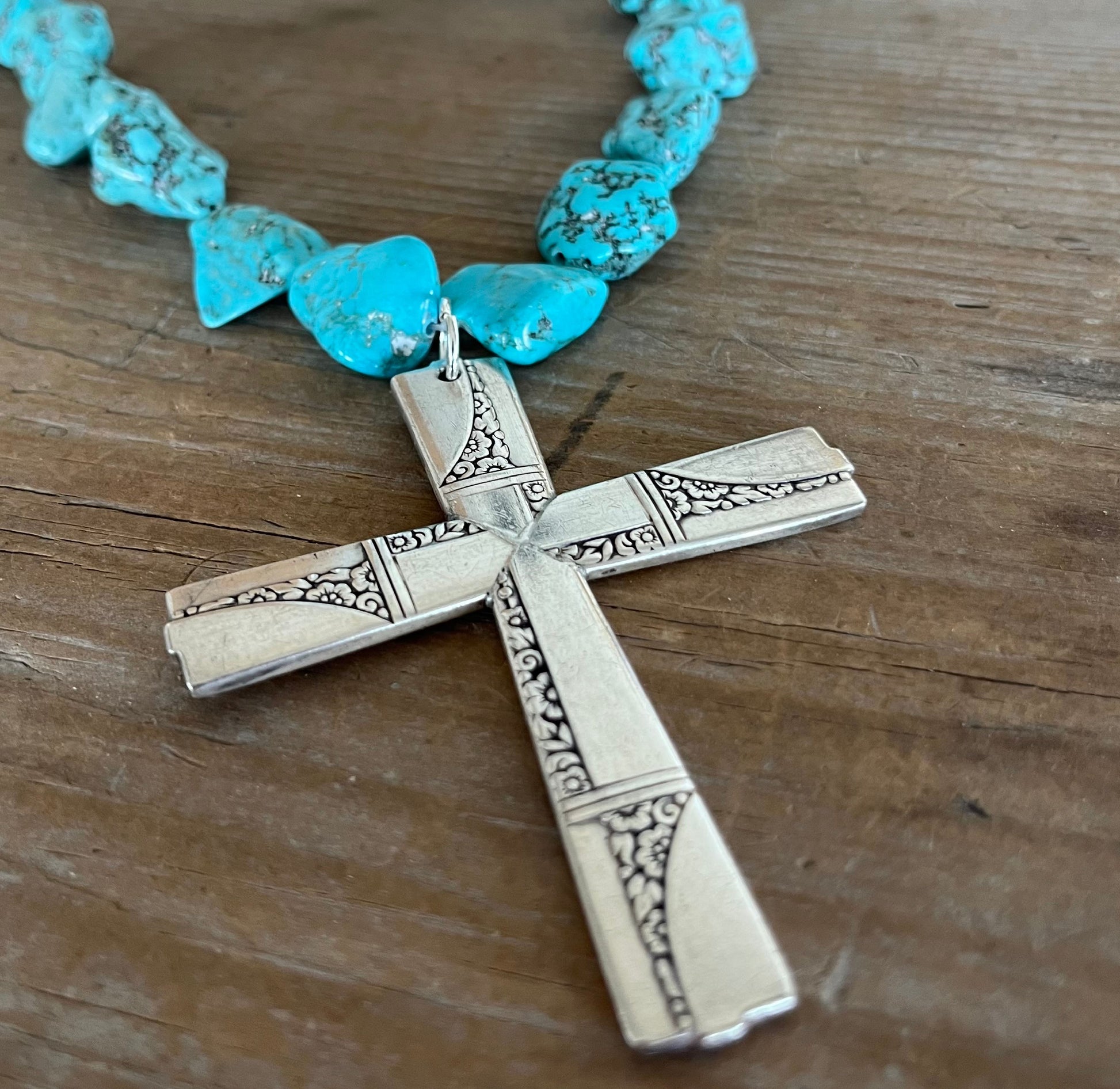 Close-up of cross pendant made from four vintage Caprice spoon handles - upcycled silverplate statement piece