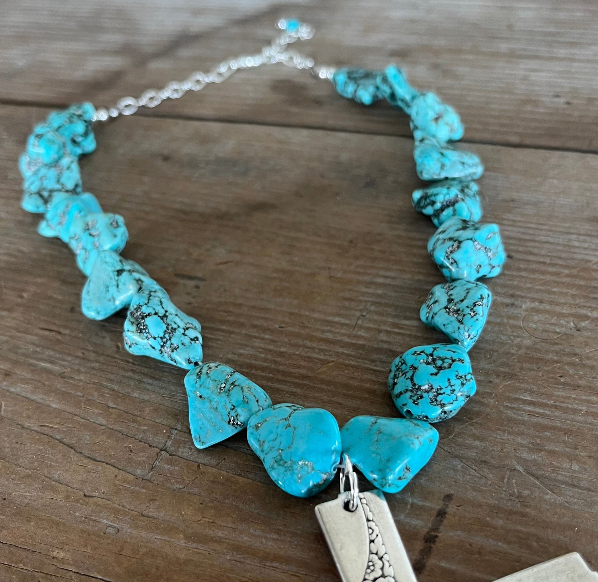 Chunky turquoise howlite beads with silverplate accents on adjustable choker necklace with spoon cross