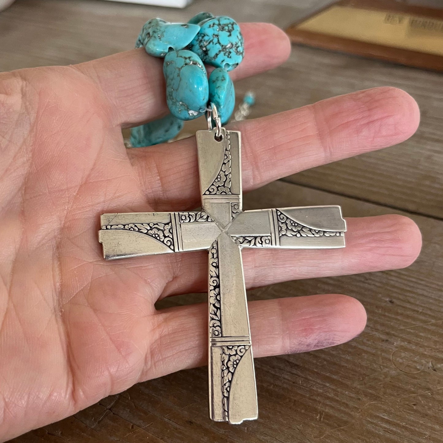 Close-up of cross pendant made from four vintage Caprice spoon handles - upcycled silverplate statement piece
