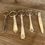 Vintage spoon handle keychains handcrafted from upcycled antique silverware multiple patterns displayed