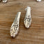 Close-up of handcrafted Evening Star pattern silverplate knife vase showing polished hollow handle detail