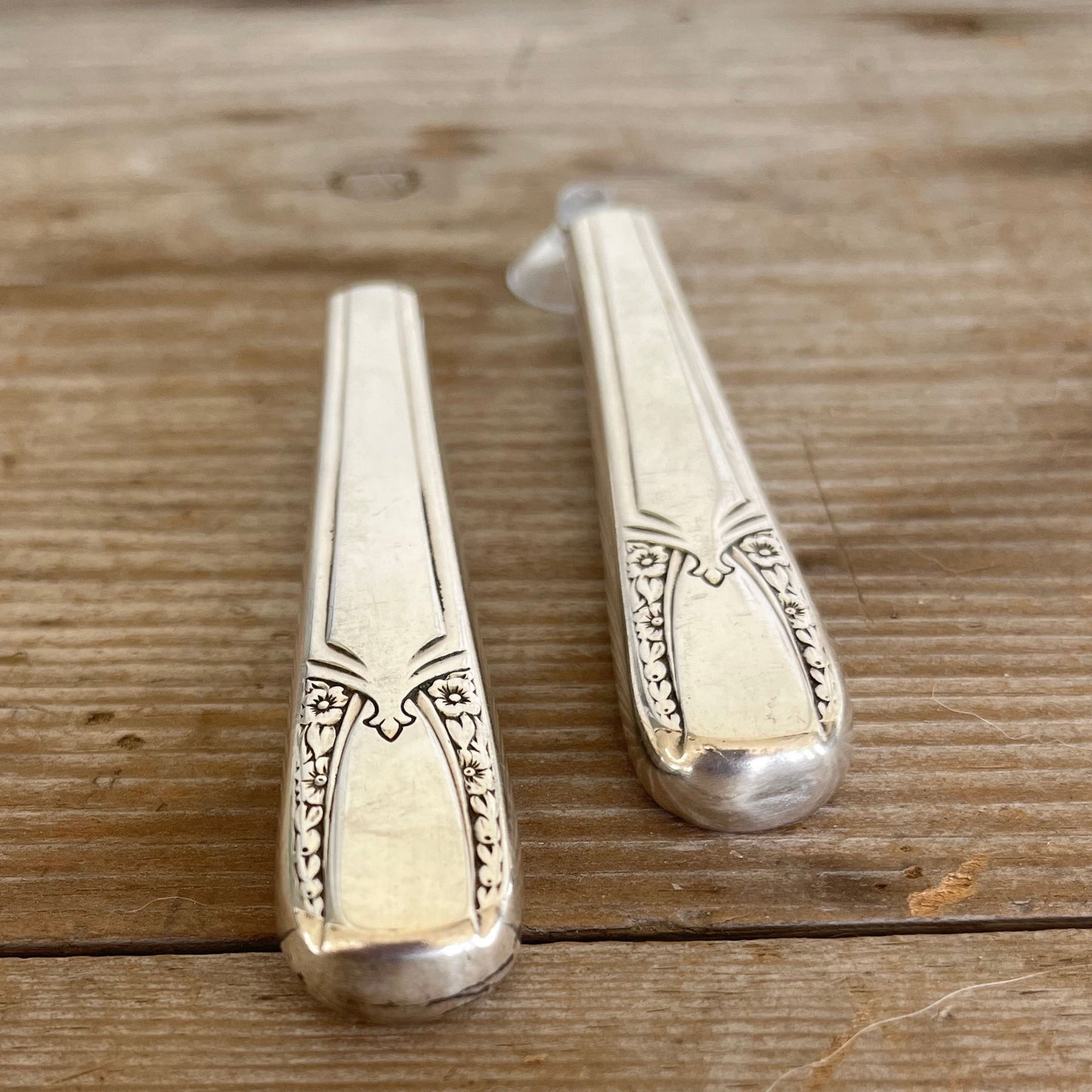 Close-up of handcrafted 1938 William Rogers Talisman knife vase showing polished hollow handle and decorative art deco pattern