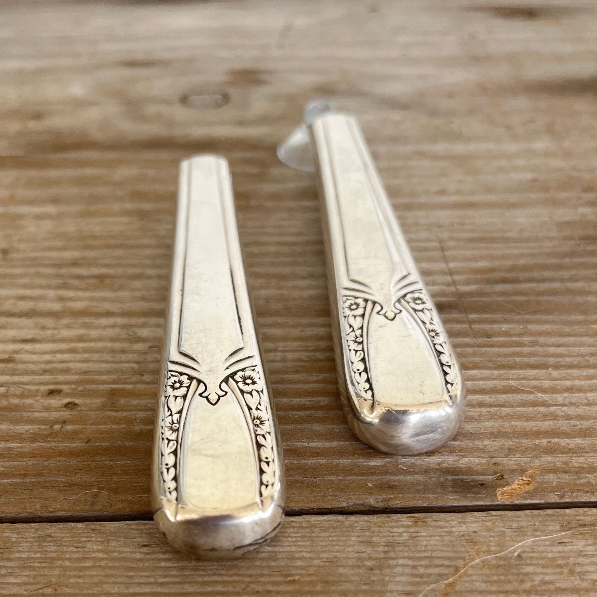 Close-up of handcrafted 1938 William Rogers Talisman knife vase showing polished hollow handle and decorative art deco pattern