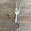 Vintage fork keychain shaped into peace sign hand with upcycled antique silverware