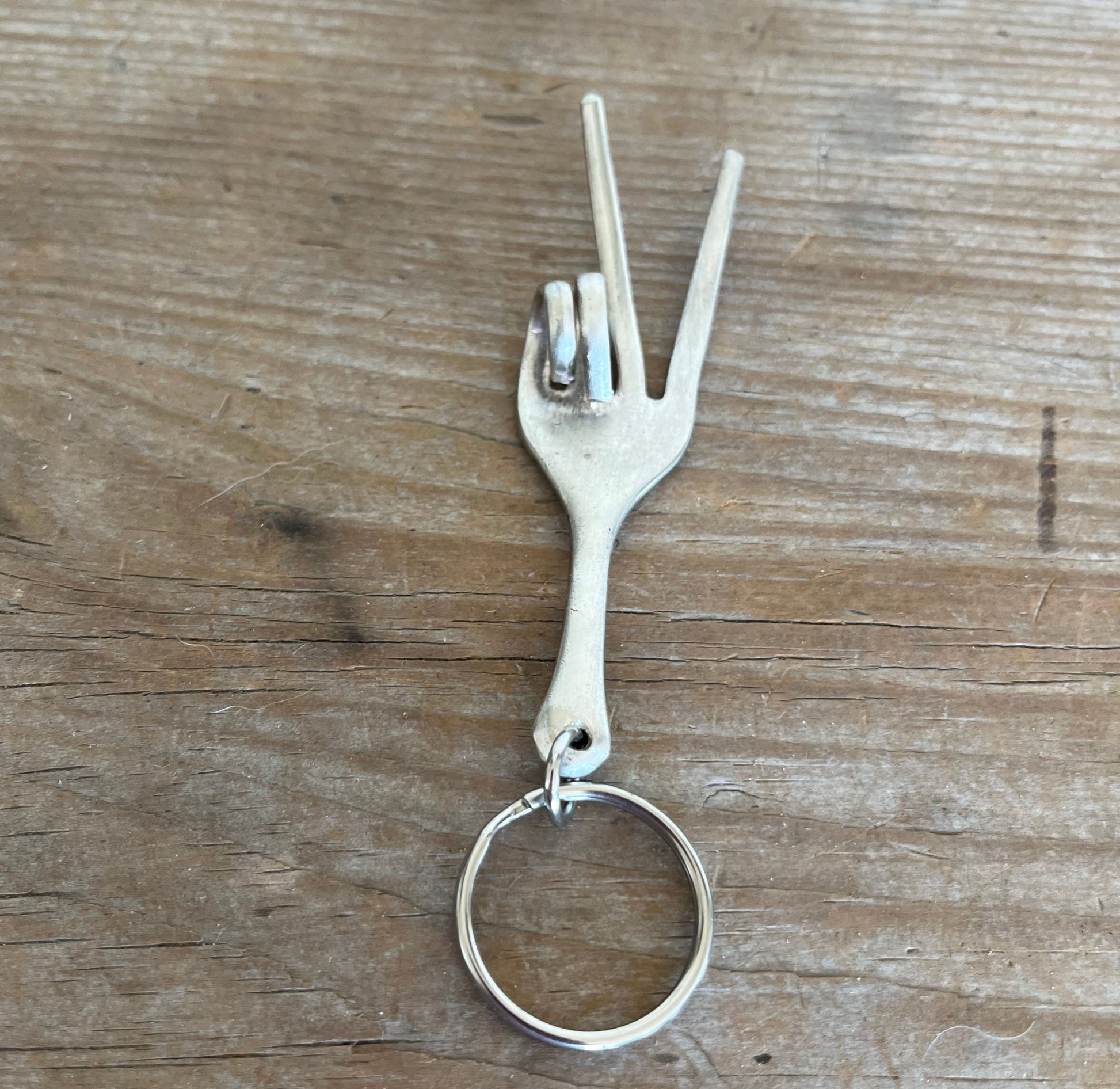 Vintage fork keychain shaped into peace sign hand with upcycled antique silverware