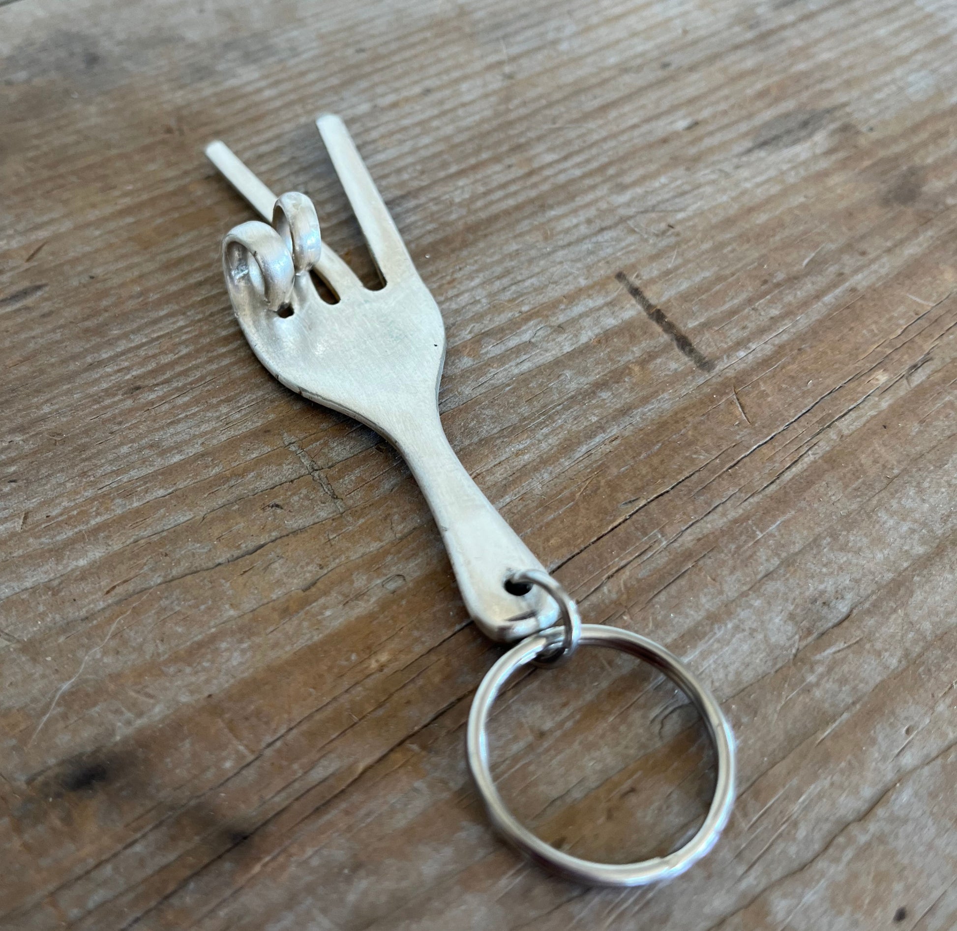 Handmade peace sign keychain from upcycled vintage fork with two-finger hand gesture