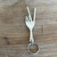 Peace sign fork keychain handcrafted from upcycled vintage silverware shaped into hand gesture