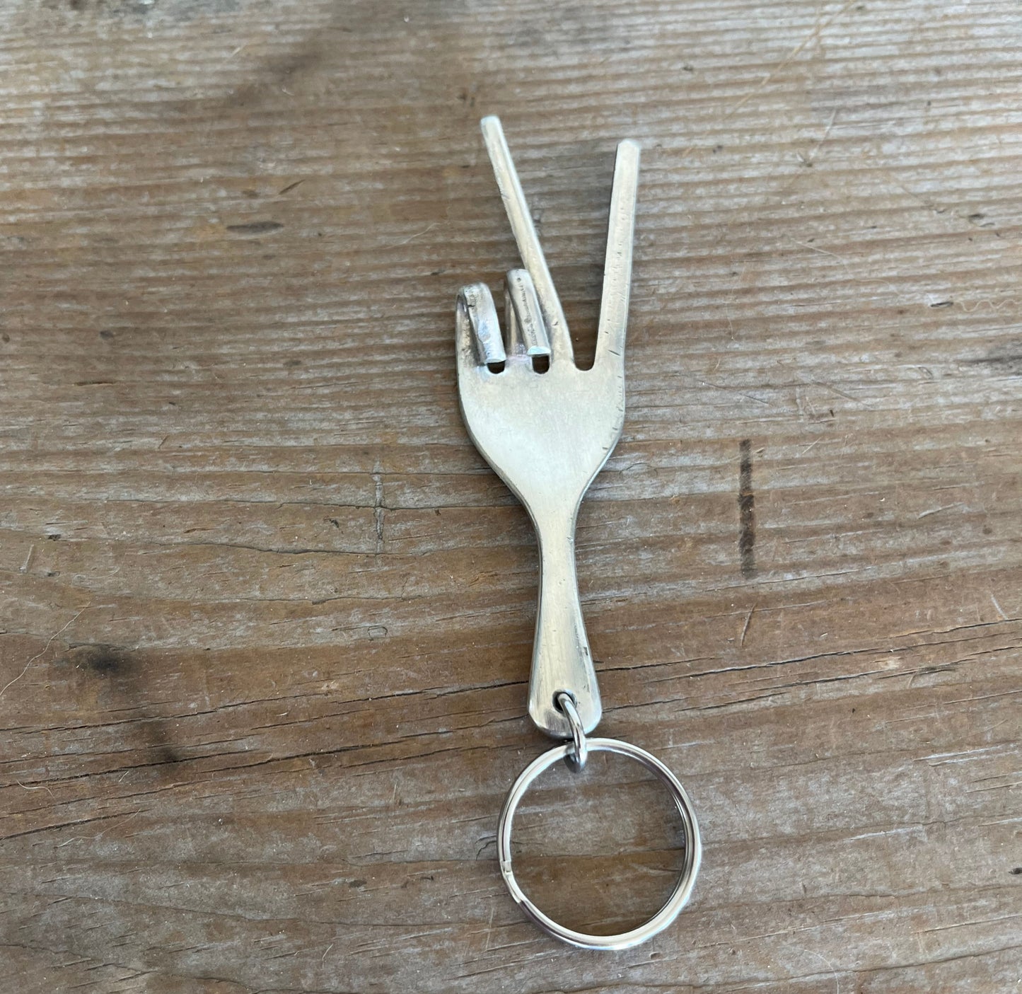 Peace sign fork keychain handcrafted from upcycled vintage silverware shaped into hand gesture