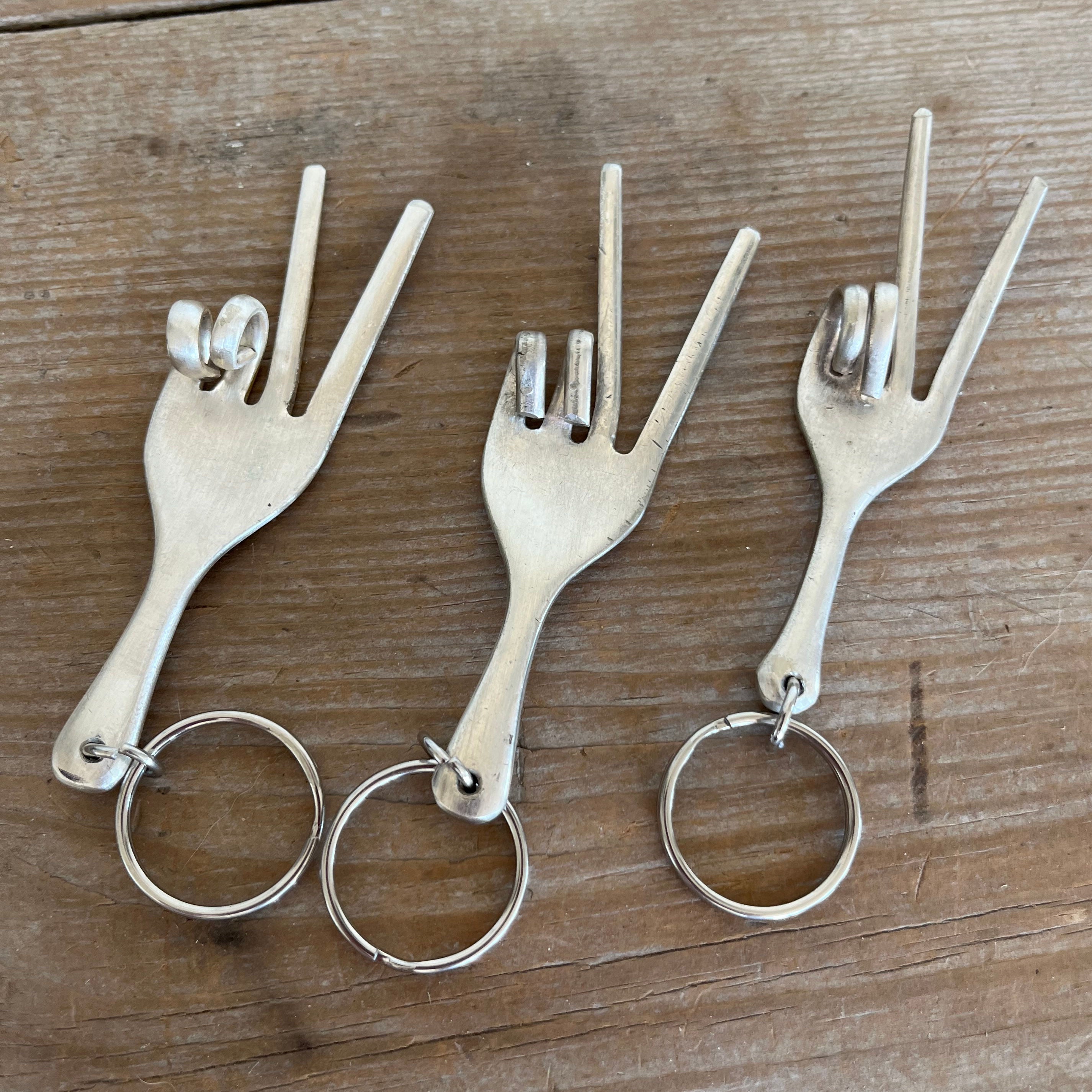 Three upcycled vintage silverware fork keychains handcrafted into hand gesture for peace by Laughing Frog Studio