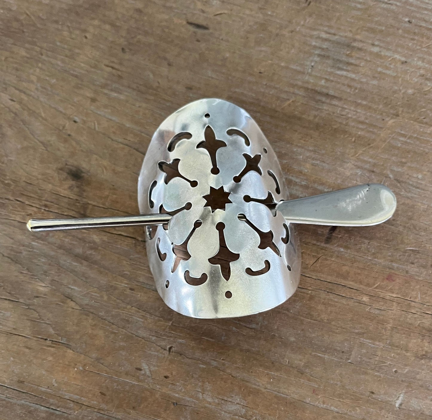 Top view of handcrafted cake server hair barrette with unique punched detailing - upcycled vintage silverware accessory - Laughing Frog Studio
