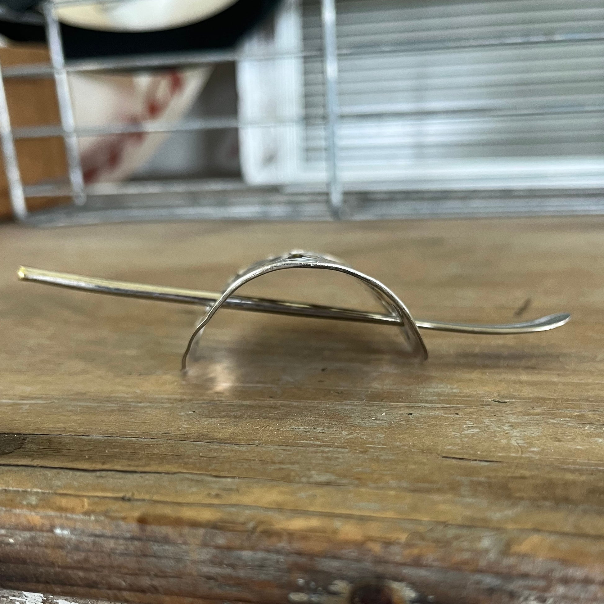 Side view of crescent-shaped cake server ponytail barrette showing curve and texture - upcycled vintage silverware - Laughing Frog Studio