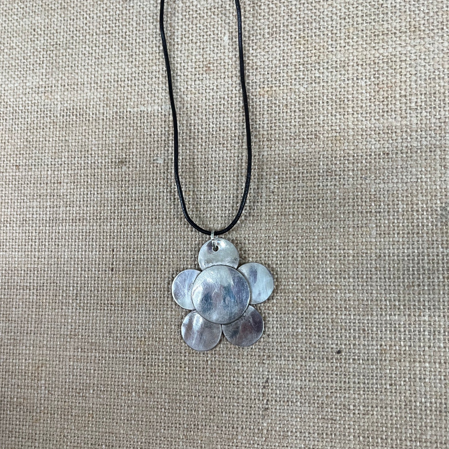 Close up of vintage silverplate daisy spoon necklace leather cord - handcrafted from upcycled vintage silverware - Laughing Frog Studio