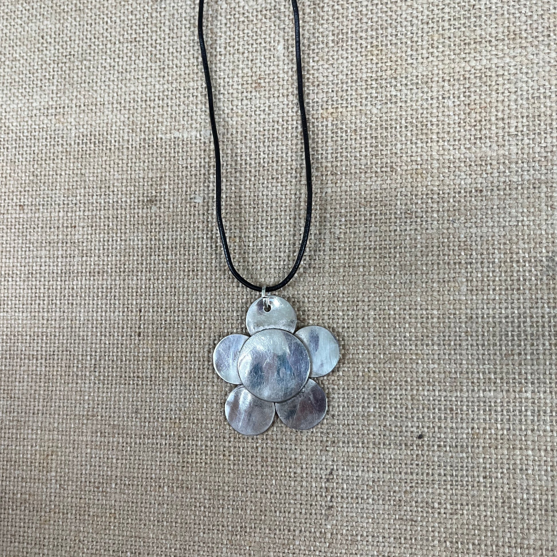 Close up of vintage silverplate daisy spoon necklace leather cord - handcrafted from upcycled vintage silverware - Laughing Frog Studio