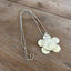 Flat lay of vintage silverplate daisy spoon necklace on ball chain - Spoon Necklace - handcrafted from upcycled vintage silverware - Laughing Frog Studio