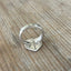 Detail of handcrafted spoon heart ring showing antique silverplate patina and artisan metalwork