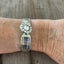 Regent spoon link bracelet with rhinestone button modeled on wrist - handcrafted upcycled artisan silverware jewelry