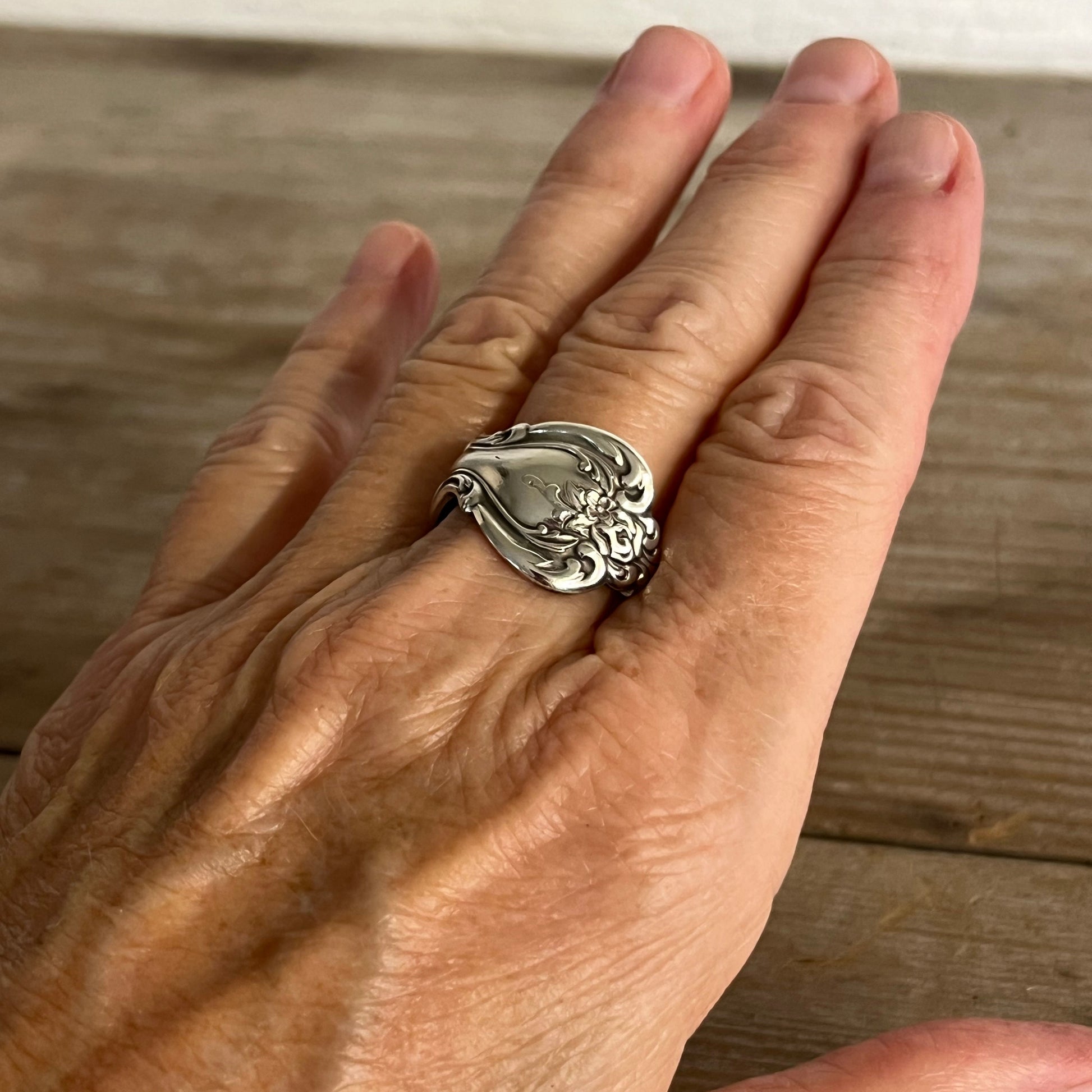 INTERLUDE spoon ring worn on finger displaying size and fit of upcycled silverware ring
