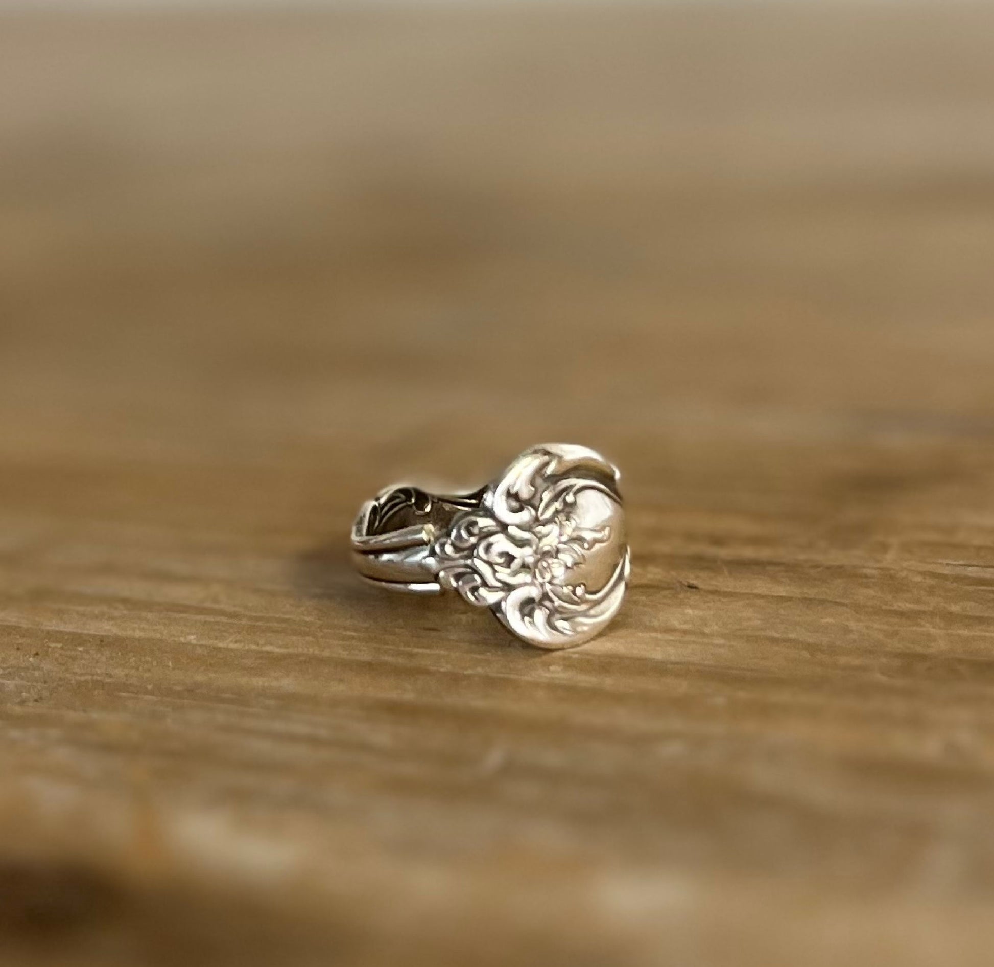 Close-up of INTERLUDE pattern spoon ring showing vintage silverware detail and craftsmanship