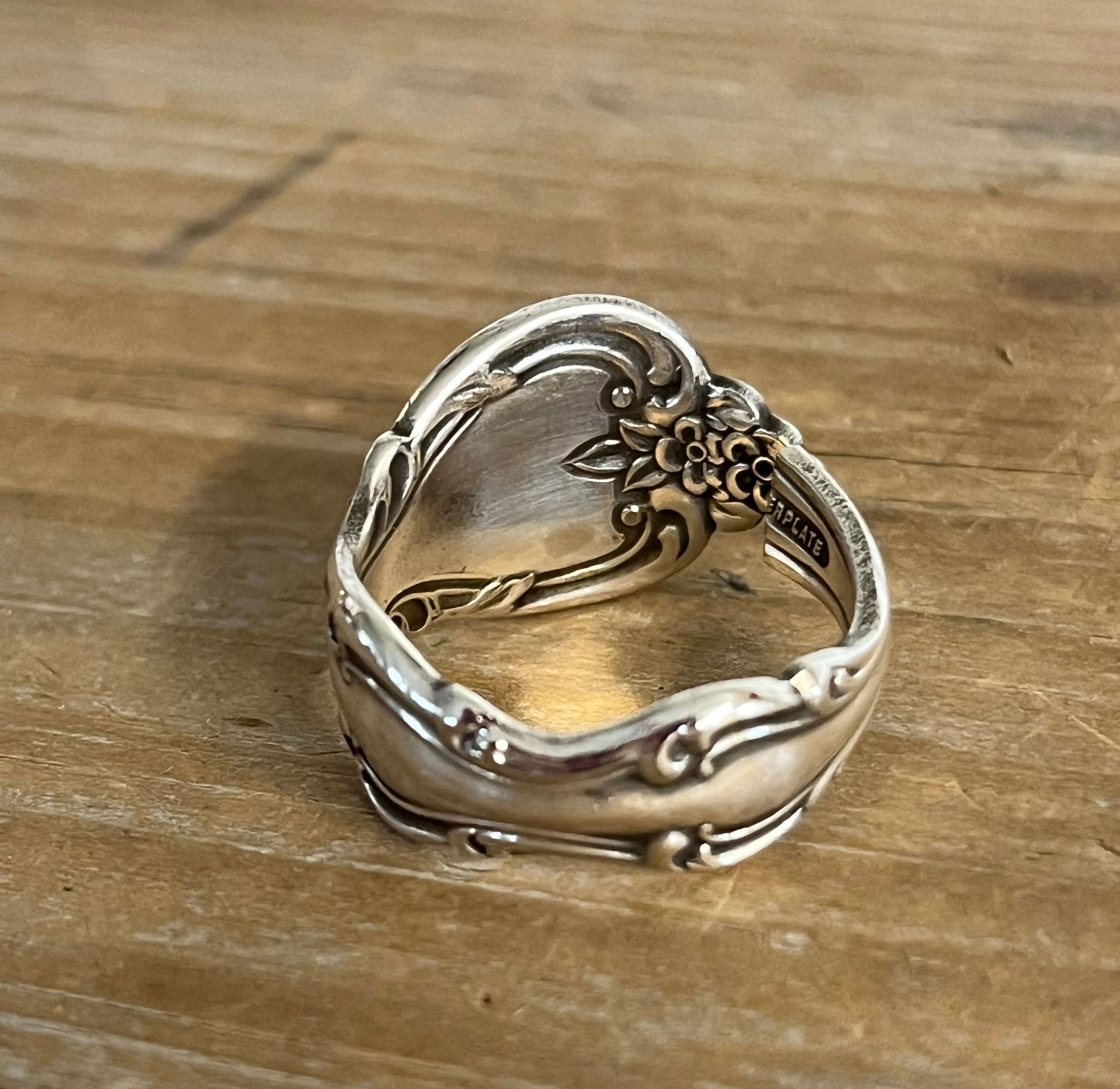 Top view and interior view of INTERLUDE pattern spoon ring showing vintage silverware detail and markings