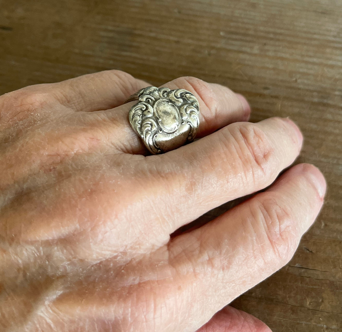 Victorian scrollwork Oxford spoon ring shown on hand - handcrafted from upcycled vintage silverware - Laughing Frog Studio