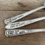 Close-up of hand-stamped Extra Spoon text on vintage silverplate spoon handles