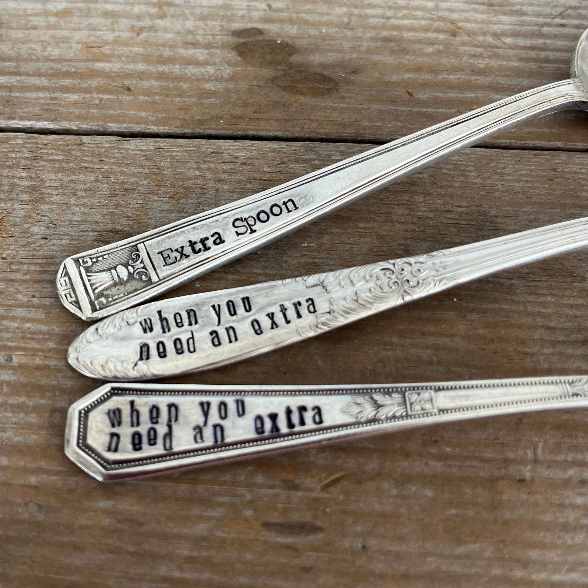 Close-up of hand-stamped Extra Spoon text on vintage silverplate spoon handles